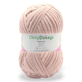 A skein of Okey Dokeys brand Jumbo Velvet Chenille Yarn in pink color.